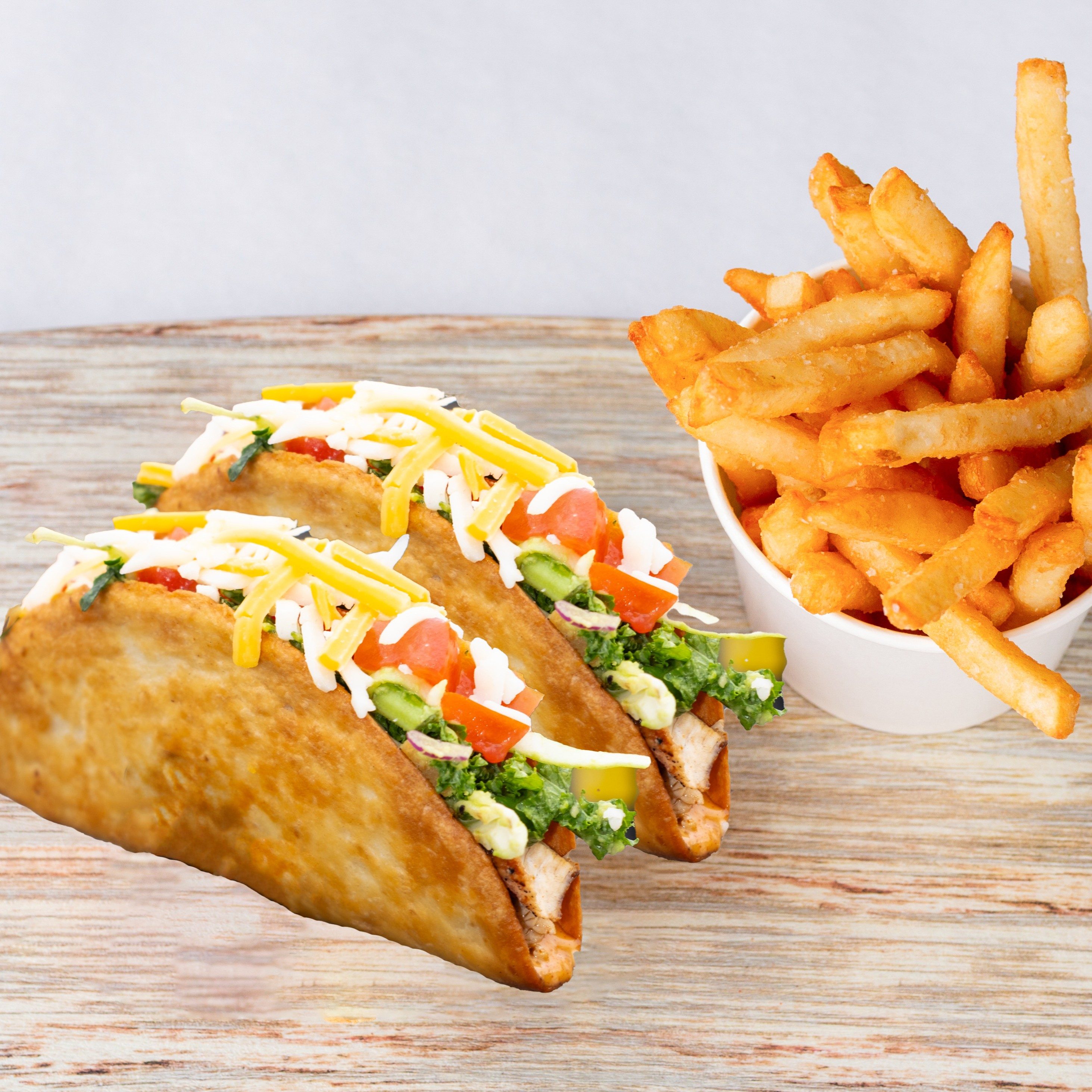 Two Crunchy Tacos with fries.